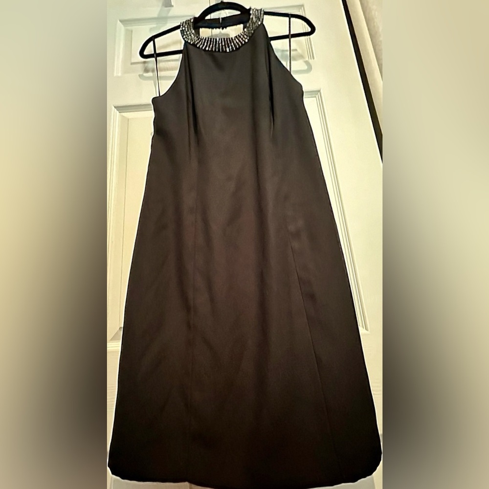 Women's little black dress with a halter neck and beaded accents.